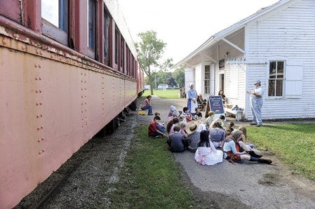 Don Konken talks to Banfield fourth-graders about hobos riding the trains in the 1800s during Living History Day at the Mower County Historical Society. Eric Johnson/photodesk@austindailyherald.com