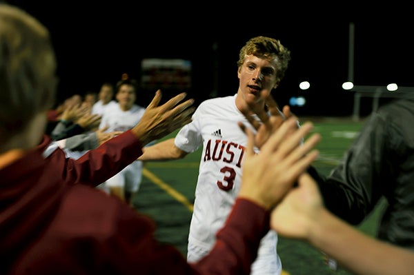 Austin's Kory Potach and his teammates high five Packer fans after Austin's 1-0 win over Faribault in Art Hass Stadium Thursday. Rocky Hulne/sports@austindailyherald.com