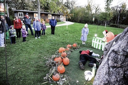 Riley Norton, playing Linus faints, as Cleopatra Carlson playing Sally watches as the two take part in acting out "It's the Great Pumpkin Charlie Brown," during the Jay C. Hormel Nature Center's Halloween Warm-up Saturday night. Eric Johnson/photodesk@austindailyherald.com