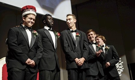 Mitchell Whalen is crowned 2015 Austin Homecoming King Wednesday afternoon in Knowlton Auditorium. With him are king candidates, from left, Ochan Ochogi, Dean Maric, Nate Conner and Seth Clasen. Eric Johnson/photodesk@austindailyherald.com