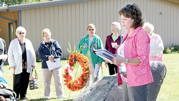 Red Cedar Chapter historian Cheryl Potter about the World War I memorial boulder at its new home on the lawn of the Mower County Historical Society Lawn during a rededication ceremony on Friday. Jason Schoonover/jason.schoonover@austindailyherald.com