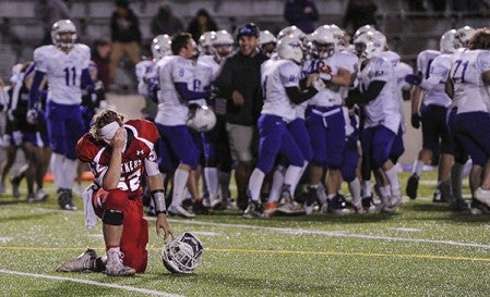 Austin’s Damian Ryks takes a knee as Red Wing celebrates their overtime win over the Packers Friday night at Art Hass Stadium. Eric Johnson/photodesk@austindailyherald.com