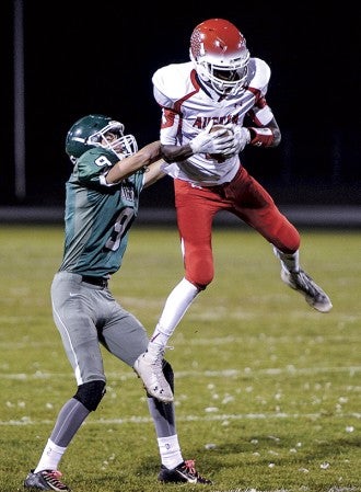 Austin receiver Jany Gash pulls in a high pass in front of Faribault’s TJ Hunt during the second quarter in Faribault. Eric Johnson/photodesk@austindailyherald.com