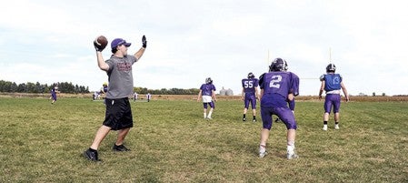 Tyler Sloan drops back to throw while working with Grand Meadow’s scout team as the Superlarks prepared for Spring Grove Wednesday night.  