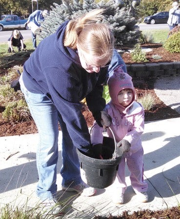 4-H parent Sara McMahon and her daughter, McKenzie work during a planting Oct. 10. 