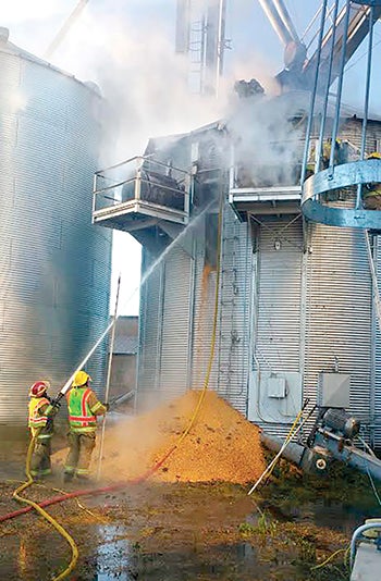 Firefighters battle a grain dryer fire on the Tangren farm near Dexter.  -- Photo provided by Sheila Tangren