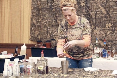 Sara Srsen of Sweet’s Hotel in LeRoy makes a drink during the Best Bartenders Contest at the Hormel Historic Home Wednesday night.