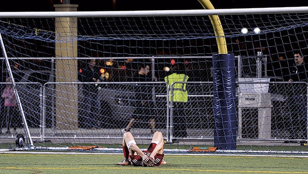 Austin’s Corbin Munger lays in front of the Austin goal after Rochester Lourdes’ two overtime win in the Section 1A title game in Rochester Thursday night. Photos by Eric Johnson/photodesk@austindailyherald.com
