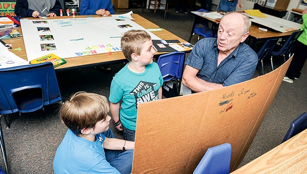 Mentor Mark Spitzer works with Neveln Elementary Students Izaac Geike, center, and Kaden Case last school year. Spitzer was taking part in the Science Fair Mentors Program. -- Herald file photos