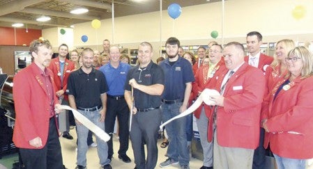 Sears celebrated its move from Oak Park Mall to its new location next to Pizza Ranch with an open house. Chamber Ambassadors joined in the celebration with a ribbon cutting inside the newly renovated store. Pictured at center, cutting the ribbon, is Sears Hometown Store owner Corey Squires.