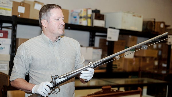 John Haymond, executive director of the Mower County Historical Society, holds a musket of the kind that would have been used during the U.S.-Dakota War of 1862. Haymond has authored a book from the military law aspect of the trials that grew from the end of the conflict. Eric Johnson/photodesk@austindailyherald.com