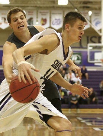 Tom Aase from the University of Sioux Falls tries to get a step past the reach of Jimmy Roth #10 from Upper Iowa in the first half of their game last season.  (Photo by Dave Eggen/inertia)