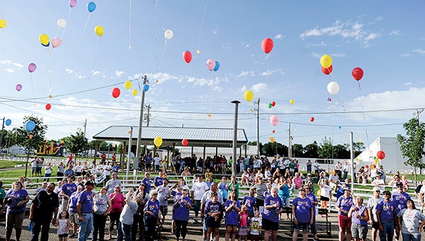 Survivors and supporters let their balloons go following the survivors walk Saturday night at the Relay for Life at the Mower County Fairgrounds this past July. -- Herald file photo