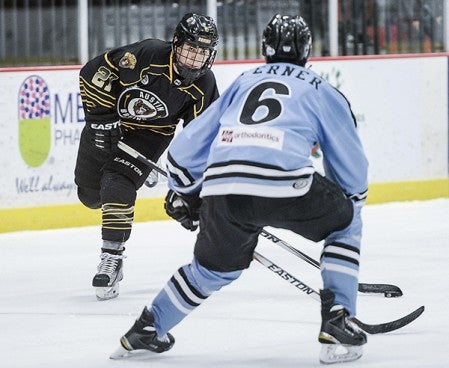 The Austin Bruins AJ Drobot looks to shoot against Coulee Region’s Brady Ferner during the second period Friday night at Riverside Arena. Eric Johnson/photodesk@austindailyherald.com