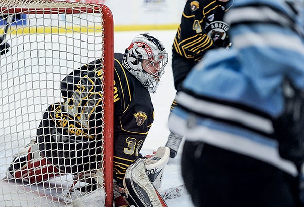 Austin Bruins’ goalie Kristofer Carlson looks back for the puck during the first period against Coulee Region Friday night at Riverside Arena. Eric Johnson/photodesk@austindailyherald.com