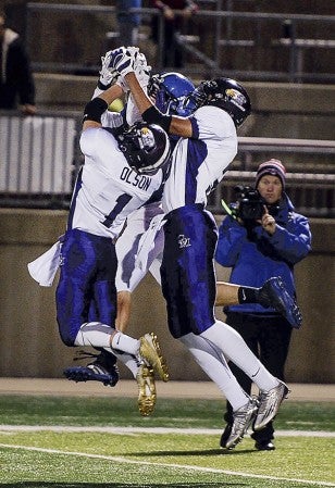 Grand Meadow’s Brenn Olson and Terrell Rieken vie for a ball with Waubun receiver Dayton Makey in the second quarter during the Minnesota Class 9-Man State Football Tournament semifinals Saturday night at St. Cloud State University. Eric Johnson/photodesk@austindailyherald.com