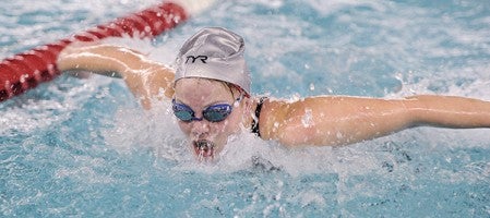 Austin’s Abby Schammel swims the 100 butterfly during the prelims for the Section 1A Girls Swimming Meet Wednesday night at Bud Higgins Pool. Eric Johnson/photodesk@austindailyherald.com