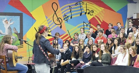 Reina Del Cid and guitar player Toni Lindgren perform for students Friday morning in the choir room at Austin High School. The two then answered questions about their time in the music industry. Photos by Jenae Hackensmith/jenae.hackensmith@austindailyherald.com