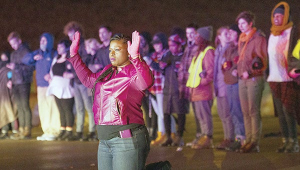 A protester knelt in front of others on Interstate 94 in Minneapolis Monday night, Nov. 16, 2015, refusing to leave after police declared the gathering illegal. Many were eventually arrested. Judy Griesedieck/For MPR News