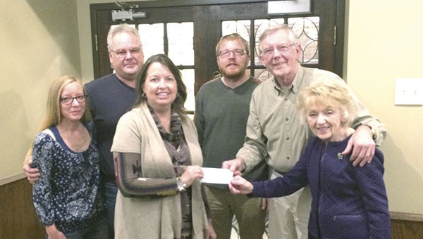 The Austin Area Landlord Association recently donated $300 to the Austin Community Scholarship Committee.  Pictured are: Peter Grover of the Austin Area Landlord Association hands a $300 check to Alice Holst and Kathy Green of the Austin Scholarship Committee, while landlord association members look on. Photo provided