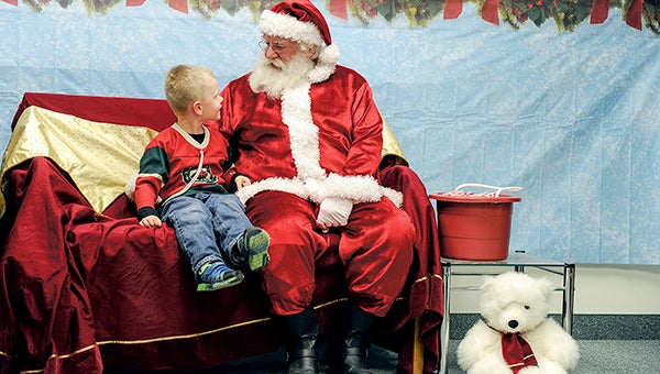 Riley Clayton tells Santa Claus what he wants for Christmas during Christmas in the City last year. -- Herald file photos