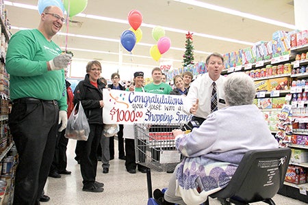 Hy-Vee manager Todd Hepler explains to Mary Flicek that she and her husband, Mel, won a $1,000 gift card to Hy-Vee.