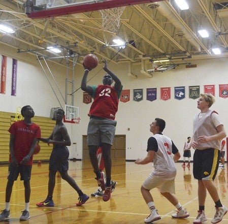 Austin's Oman Oman goes up for a shot in the paint in practice in Packer Gym Thursday. Rocky Hulne/sports@austindailyherald.com