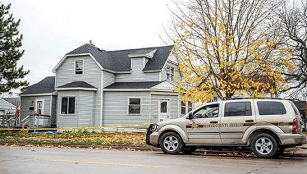 A Mower County Sheriff’s deputy sat outside a home along Eighth Street NE that was cordoned off with police tape and was believed to be involved in the death of David Madison.