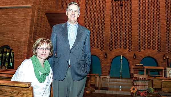 Pastor Glenn Monson and his wife Ruth pose for a picture in Our Savior’s Lutheran Church’s sanctuary earlier this week. The couple is moving to Rochester where Pastor Monson will become pastor of Mount Olive Lutheran Church. Sundy was his last day. Eric Johnson/photodesk@austindailyherald.com