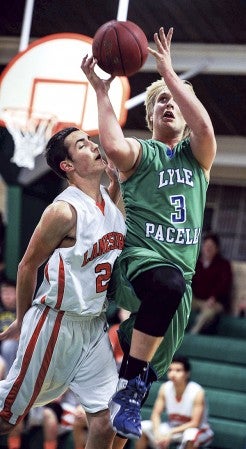 Lyle-Pacelli’s Lee Bauer goes up for a contested layup against Lanesboro’s Markus Mulvihill in the first half Thursday night at Pacelli. Eric Johnson/photodesk@austindailyherald.com