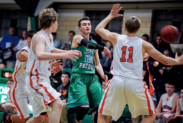 Lyle-Pacelli’s Noah Jiskra dumps a no-look off in traffic against Lanesboro Thursday night at Pacelli. Eric Johnson/photodesk@austindailyherald.com