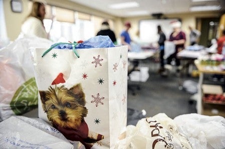 A room at the Mower County Health and Human Services is packed with gifts in the Holiday Giving Program Saturday night. Eric Johnson/photodesk@austindailyherald.com