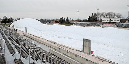 The dome over Art Hass Stadium begins to inflate Tuesday morning. 