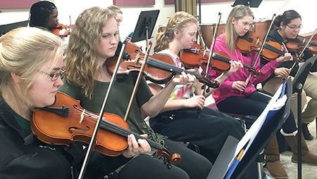 Orchestra students practice for the upcoming holiday show on Monday. The concert combines band, orchestra and choir into one concert. -- Photo provided