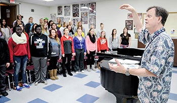Choir director Brian Johnson leads a rehearsal Thursday. 