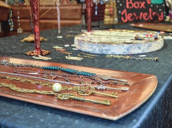 Items from Swing Box Jewelry are laid out on the table. 
