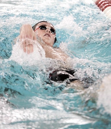 Austin’s Ben Walker swims the backstroke portion of the 200 IM against Rochester Century Tuesday night at Bud Higgins Pool. Eric Johnson/photodesk@austindailyherald.com
