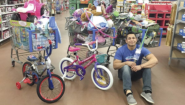 Thomas Herrera poses with toys he purchased at Walmart for the Salvation Army. Herrera raised $2,000 through Gofundme.com to purchase the toys. Photo provided