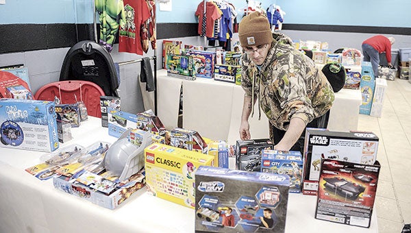 Isaac Baker looks through toys during the annual Salvation Army’s Toy Shop distribution Thursday morning at the Salvation Army.  Photos by Eric Johnson/photodesk@austindailyherald.com