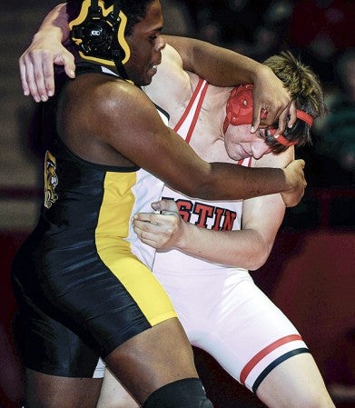 Isaac Arjes grapples with Mankato East’s Luther Marc at 220 pounds Tuesday night in Ove Berven Gym. Eric Johnson/photodesk@austindailyherald.com