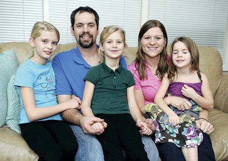 Ben and Allyson Klankowski with their three children, Morgan, from left, Madeline and Marlie have opened their home up several foster children and are now in the process of adopting one of those children. 
