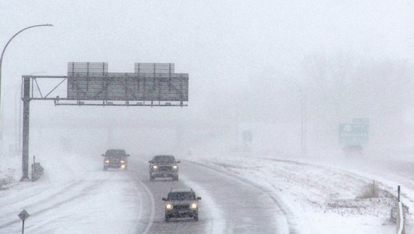 Cars drive on Interstate 90 Monday shortly after noon as snow begins falling and a large snow storm moves into the area.  -- Photos by Jason Schoonover/jason.schoonover@austindailyherald.com