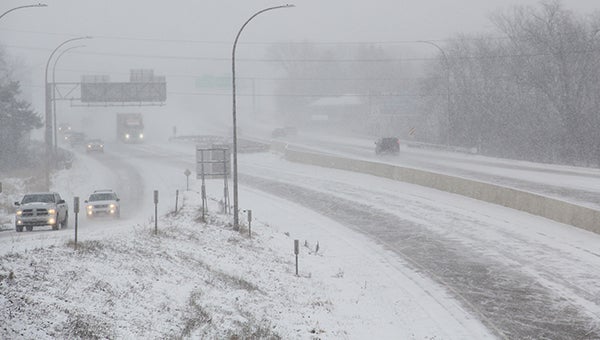 Cars drive on Interstate 90 Monday shortly after noon as snow begins falling as a large snow storm moves into the area. Jason Schoonover/jason.schoonover@austindailyherald.com
