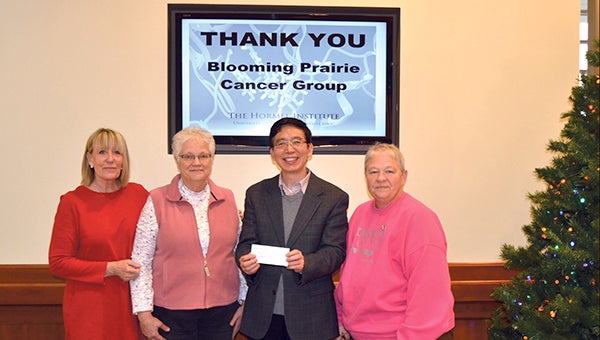Leaders with the Blooming Prairie Cancer Group present on Tuesday a $15,000 donation to Dr. Zigang Dong, Executive Director of The Hormel Institute, University of Minnesota, to support breast cancer research. The gift counts toward the $200,000 fundraising goal for the sixth annual Paint the Town Pink initiative. Pictured (left to right) are Gail Dennison, Director of Development & Public Relations for The Hormel Institute; Jennifer Milton of Blooming Prairie Cancer Group; Dr. Zigang Dong; and Cheri Krejci of Blooming Prairie Cancer Group. -- Photo provided