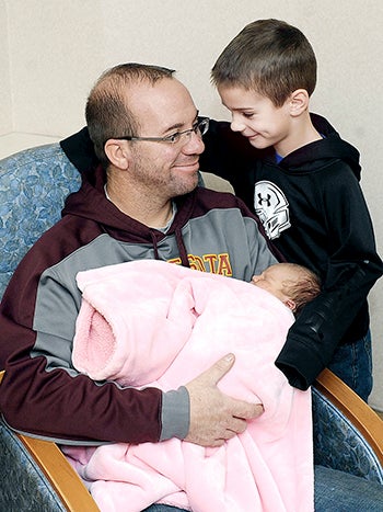 Tony Lea of Blooming Prairie and his son, Beckett, 6, smile as Tony holds the family’s newest addition, Sailor. The baby girls was the first baby of 2016 born at Mayo Clinic Health System in Austin.