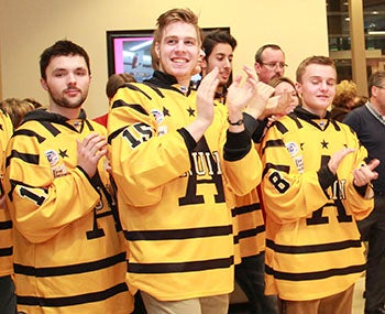 Austin Bruins players applaud during the Paint the Town Paink kickoff at The Hormel Institute on Tuesday.