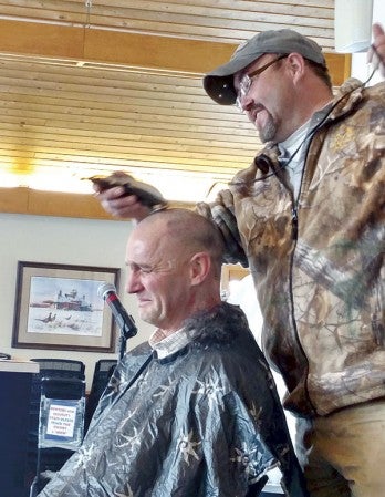 Dave White shaves Austin Utilities General Manager Mark Nibaur’s head at the Jay C. Hormel Nature Center on Monday during a 2016 kick off meeting for employees. Three workers shaved Nibaur’s head after Austin Utilities had zero safety incidents in 2015. They also used the head shaving as a raffle to raise $495 for Paint the Town Pink. Photo provided by Kelly Lady