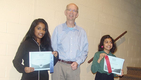 Shenali DeSilva won first place in the Pacelli Spelling Bee. Neha Nanda came in second place and both will participate the Southeast Regional Spelling be on Feb. 9 held in Rochester. They are pictured with Dan Conrad who helped out with the spelling bee. Photo provided