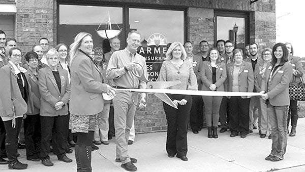 JIM BENSON AGENCY. Chamber Ambassadors held a ribbon cutting in front of the newly renovated offices of Farmers Insurance Group, Jim Benson Agency, 209 4th Ave. NE. At center are agent Jim Benson and representative Shelley Jones. Farmers Insurance offers a complete line of insurance for home, business, vehicles and more. Photo provided