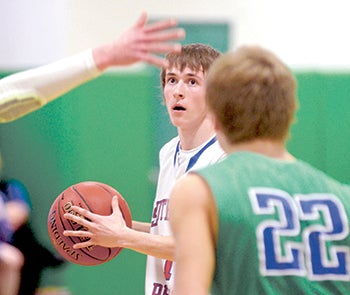 Southland’s James Landherr holds the ball against Lyle-Pacelli in Pacelli Gym 